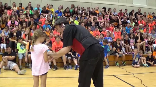 Eric performing magic at a camp